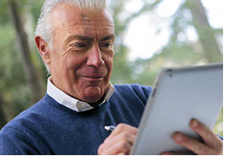 man reading newsletter on tablet